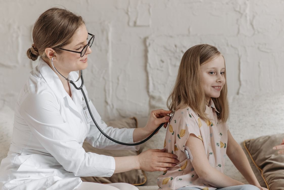 Nurse providing pediatric home care to a young girl